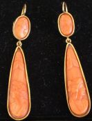 Pair of carved coral earrings set in tested as 9ct gold