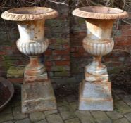 Pair of cast iron classical urns on plinths Ht 110cm Dia 57cm