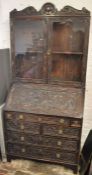 Late 19th century north European bureau display bookcase with heavily carved decoration in oak Ht