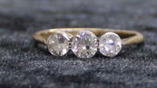 18ct gold three stone diamond ring, approx. 0.90ct, size T, 2.26g