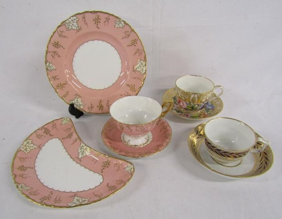 Royal Crown Derby 'Vine' pink set and 2 earlier cups and saucers gold with blue leaf pattern and