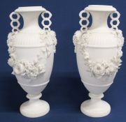 Pair of bisque porcelain vases with floral detail 26cm high - some damage