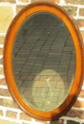 Oval oak mirror with bevelled glass approx. 88cm x 63cm