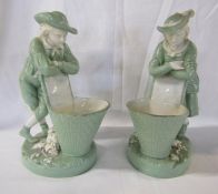 Minton green and white girl and boy leaning on a basket - marked Minton G to base - approx. 23cm