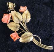 Tested as 9ct gold floral spray brooch with carved coral roses 13.1g, 7.5cm dia.