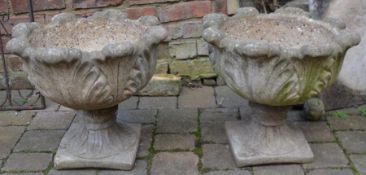 Pair of cast concrete planters on stands with acanthus leaf moulding Ht 44cm Dia 49cm