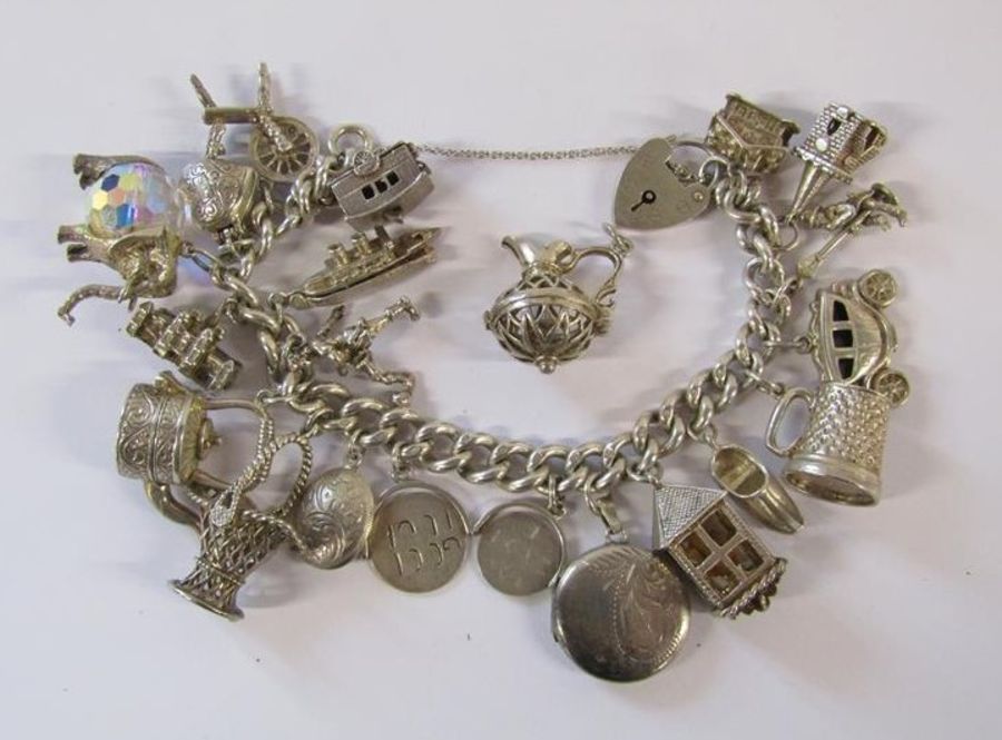 Silver charm bracelet - each link stamped - not all pendants marked - total weight 3.58ozt