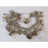 Silver charm bracelet - each link stamped - not all pendants marked - total weight 3.58ozt