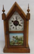 Late 19th century American mantel clock with architectural form case and lower illustrated glass