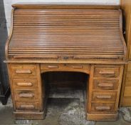 An early 20th century oak tambour front desk L 127cm D 80cm Ht 127cm