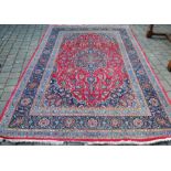 Iranian rug with red ground & blue border 305cm by 196cm