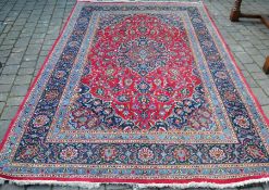 Iranian rug with red ground & blue border 305cm by 196cm