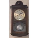 1930's Art Deco wall clock in an oak case Ht 57cm W30cm