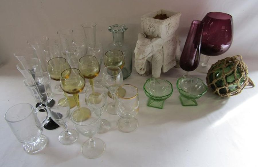 Collection of glassware includes coloured oversized glass, buoy, wine glasses and elephant plant