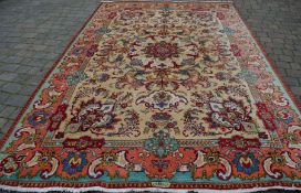 Large multi-ground Persian style carpet with central medallion 376cm by 247cm