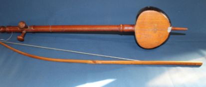 Single string musical instrument made from a coconut with bow