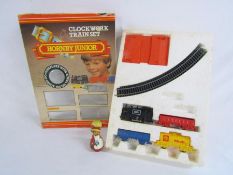 Hornby Junior clockwork train set (missing cars) and a wooden wobble head doll