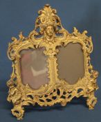 Decorative gilt metal double aperture picture frame with registration number to reverse 30cm wide