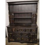 18th century oak dresser with geometric panels, some molding missing.  Ht 211cm L 157cm D 56cm