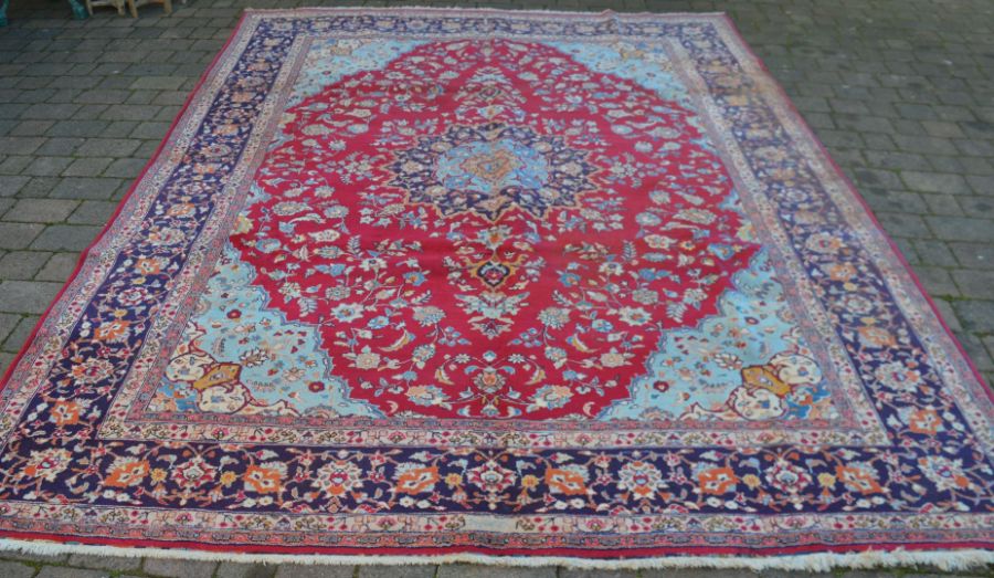 Rich red ground Persian Tabriz carpet with floral medallion & blue border 346cm by 259cm