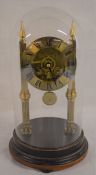 Skeleton clock under a glass dome Ht 30cm