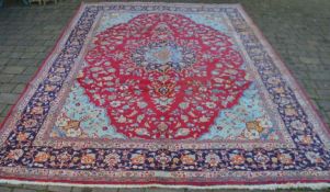 Rich red ground Persian Tabriz carpet with floral medallion & blue border 346cm by 259cm