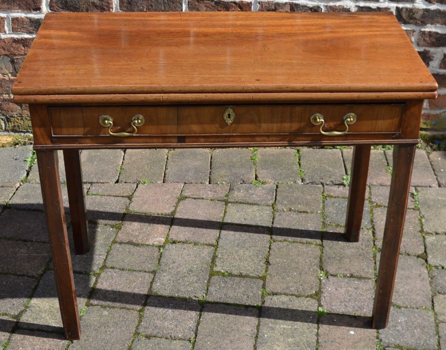 Georgian mahogany fold over tea table with under drawer with swan neck handles. Top opening to