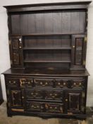 18th century oak dresser with geometric panels, some molding missing.  Ht 211cm L 157cm D 56cm