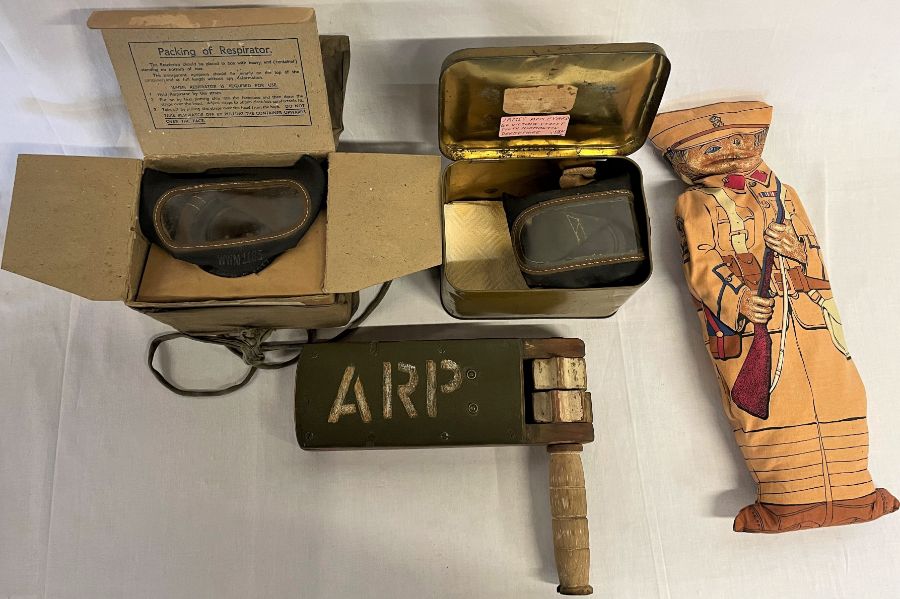 1939 WWII ARP gas rattle, WWII solider doll, gas mask in a Barringer, Wallis & Manners tin box and