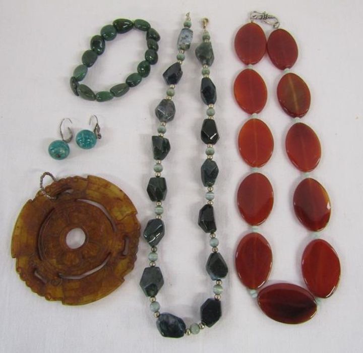 Selection of possibly semi-precious stone jewellery includes large carved pendant