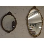 Two oval wall mirrors, largest 66cm by 40cm