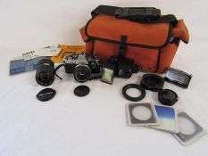Olympus OM10 camera with Olympus Zuiko lens, Miranda 700cd flash, Bell & Howell 5500361 lens,