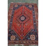 Blue and red Persian rug with central medallion 256cm x 166cm