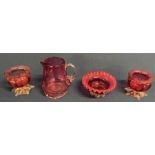 Selection of cranberry glass, including two salts, jug and dish