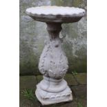 Concrete bird bath with acanthus leaf decoration