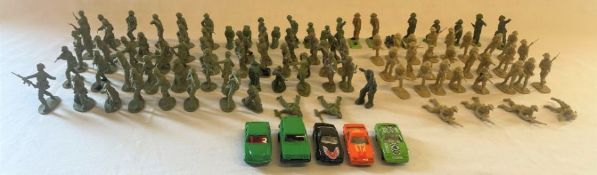 Collection of several plastic toy soldiers, including some Britains and 5 toy cars