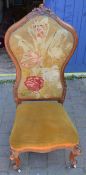 Victorian high back nursing chair in walnut on scroll legs with castors