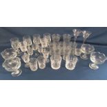 Collection of glassware includes tall twisted stem glasses, etched drinking glasses, stemmed