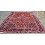 Large full pile red ground Persian Beshir carpet 4.0m by 2.9m