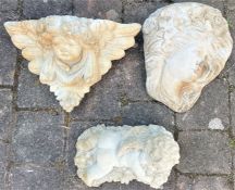 Concrete Baccus Cherub lying on a bed of grapes and two wall mounted plaques, one of a cherubs