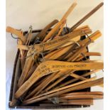 Box of wooden coat hangers, including some branded