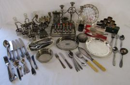 Collection of silver plate includes candlesticks, trays, dishes, cake slices etc
