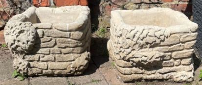 Pair of large concrete square brick planters festooned with ivy