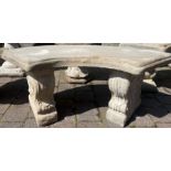 Curved concrete garden seat on classic plinths