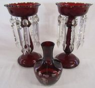 Pair of ruby glass lustres - one showing slight damage - and cased glass vase