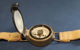 Post war RAF wrist compass on original canvas strap bearing broad arrow mark, Ref No. 6B / 2593