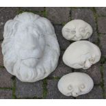 Concrete lion mask and happy faces stones