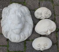 Concrete lion mask and happy faces stones