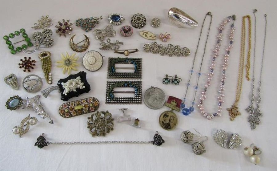 Collection of costume jewellery includes buckles, brooches, pearl necklace, earrings, mussel