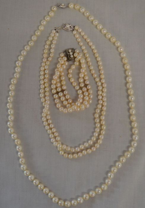 Double string of cultured pearls with clasp stamped 14ct bearing monogram for Mikimoto 36cm